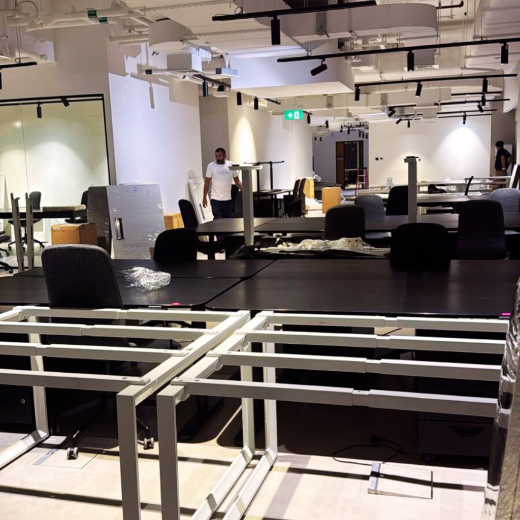 Movers in JLT (Jumeirah Lake Towers) Dubai 1 Dismantled desk frames wrapped and stacked during an office move in a Jumeirah Lake Towers building